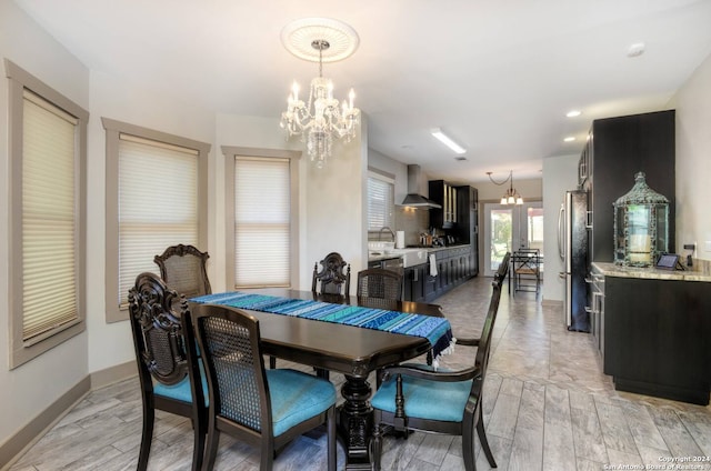 dining area featuring light hardwood / wood-style flooring and a notable chandelier