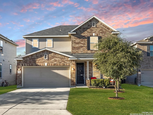 front of property with a lawn and a garage