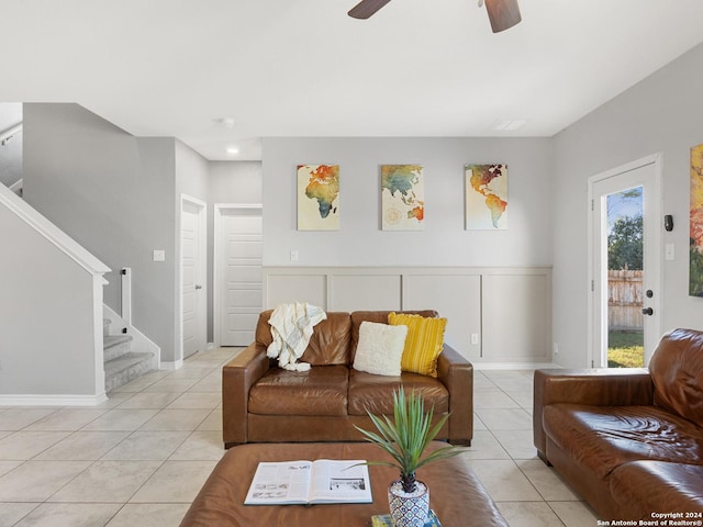 tiled living room featuring ceiling fan