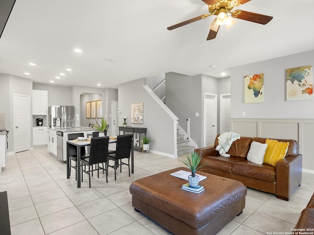 tiled living room featuring ceiling fan