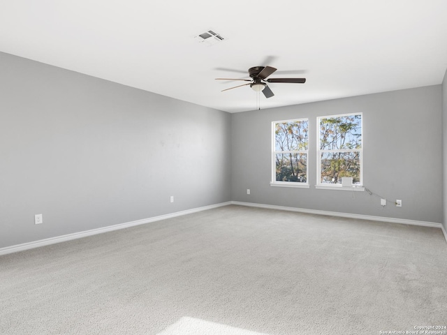 spare room with light carpet and ceiling fan