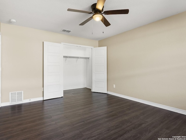 unfurnished bedroom featuring dark hardwood / wood-style flooring, a closet, and ceiling fan