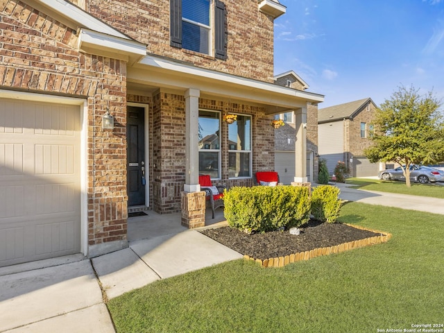 property entrance featuring a yard and a porch