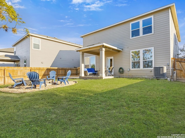 back of property featuring central AC unit, a patio area, a yard, and an outdoor fire pit