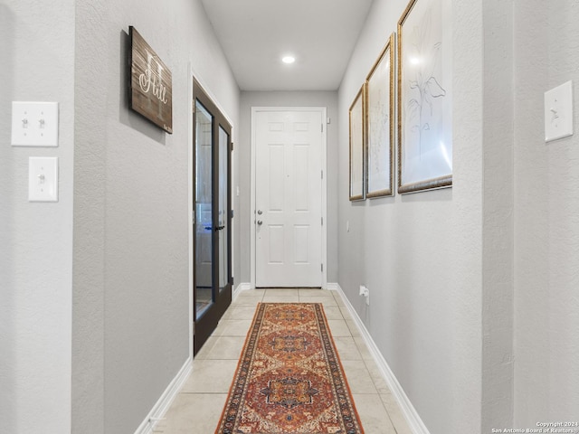 corridor with light tile patterned floors