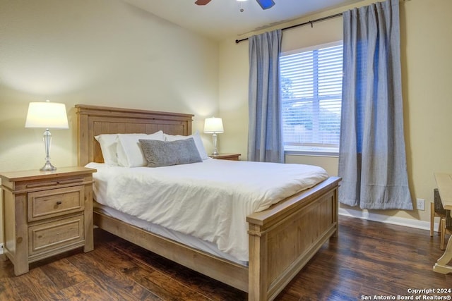 bedroom with dark hardwood / wood-style flooring and ceiling fan