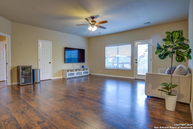 living room featuring dark hardwood / wood-style flooring, wine cooler, and ceiling fan