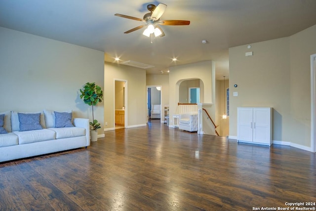 living room featuring ceiling fan and dark hardwood / wood-style flooring