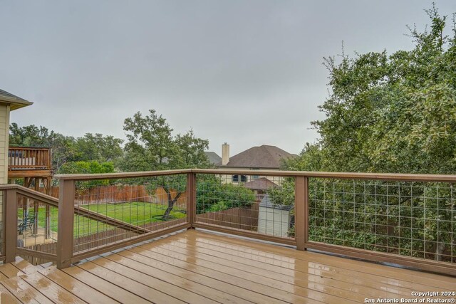 wooden deck featuring a yard