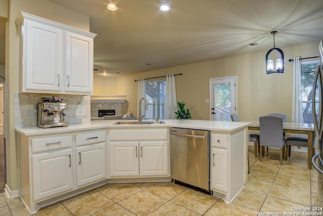 kitchen with dishwasher, white cabinets, plenty of natural light, and sink