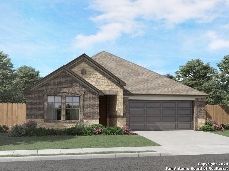 view of front of house with a garage and a front lawn