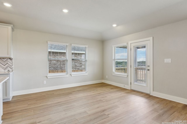 unfurnished dining area featuring light hardwood / wood-style floors