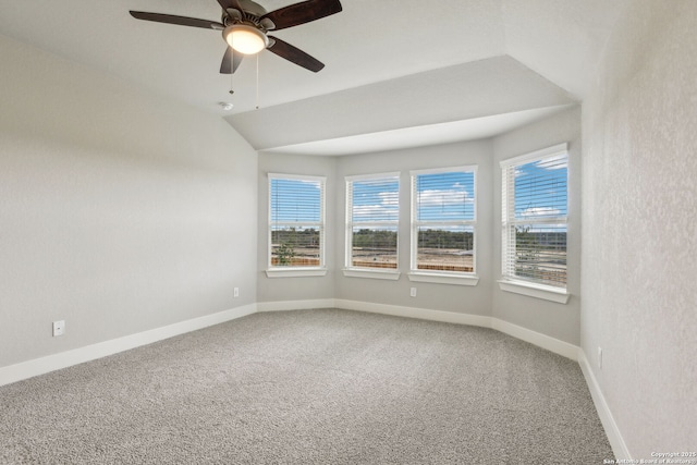 carpeted spare room featuring lofted ceiling and ceiling fan