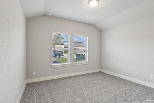 spare room with lofted ceiling and carpet