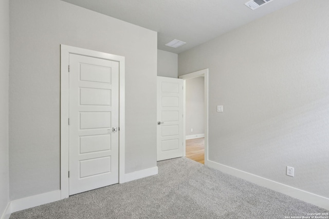 unfurnished bedroom with light colored carpet