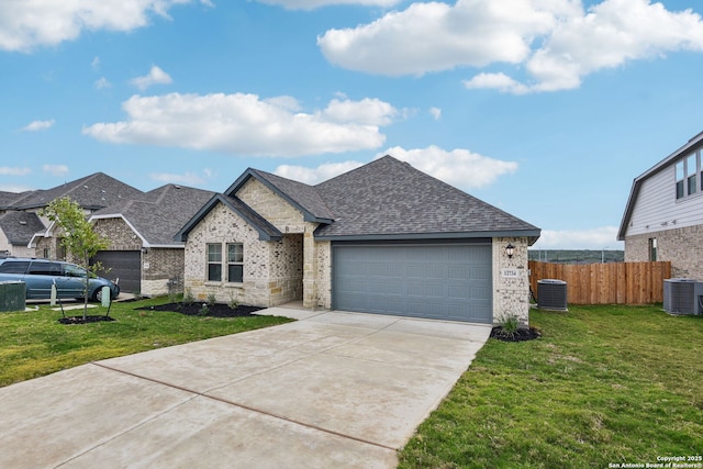 view of front of house with a garage, central air condition unit, and a front lawn