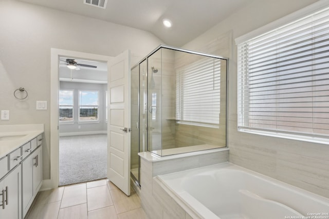 bathroom featuring independent shower and bath, lofted ceiling, vanity, ceiling fan, and tile patterned floors