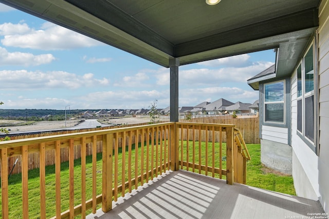 wooden terrace featuring a yard