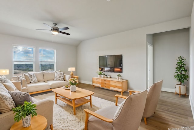 living room with lofted ceiling, hardwood / wood-style floors, and ceiling fan