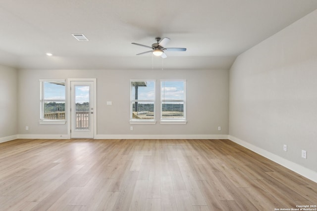 unfurnished room featuring a wealth of natural light, light hardwood / wood-style floors, and ceiling fan