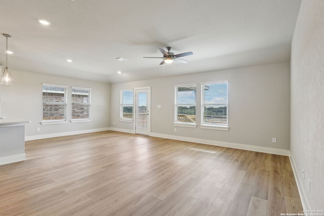 empty room with ceiling fan and light wood-type flooring