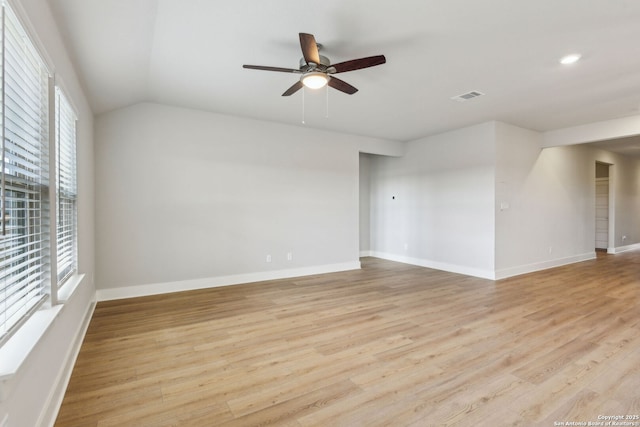 spare room featuring ceiling fan, lofted ceiling, and light hardwood / wood-style floors