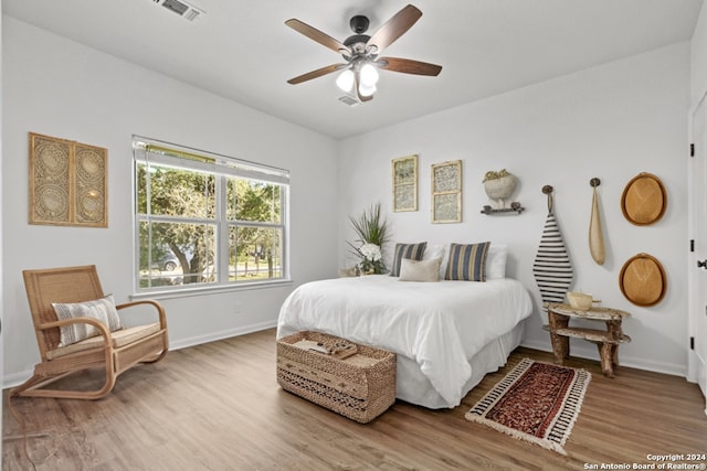 bedroom with ceiling fan and hardwood / wood-style flooring