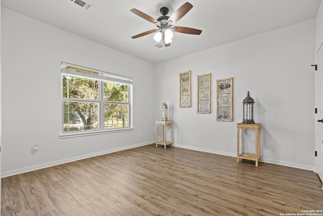 unfurnished room with hardwood / wood-style floors and ceiling fan