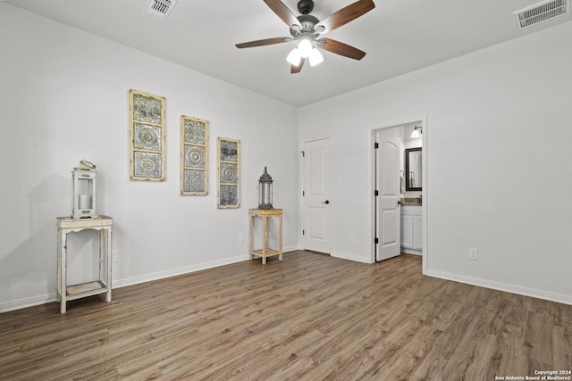 spare room featuring wood-type flooring and ceiling fan