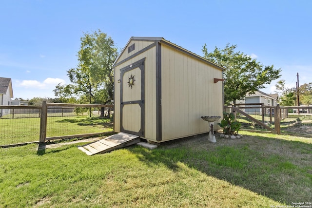 view of outdoor structure featuring a lawn