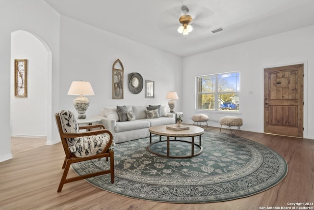 living room featuring hardwood / wood-style flooring and ceiling fan