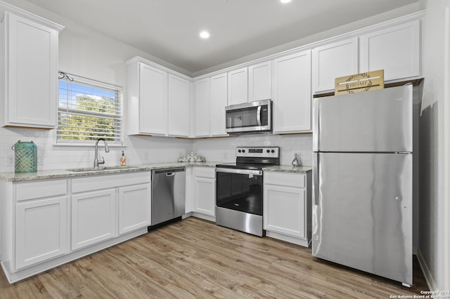 kitchen featuring white cabinets, sink, and stainless steel appliances