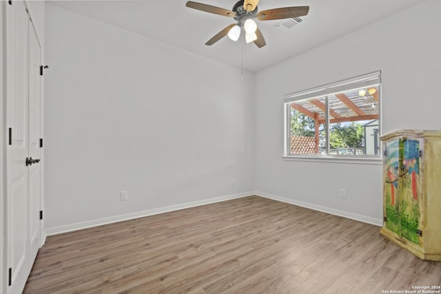 empty room featuring ceiling fan and light wood-type flooring