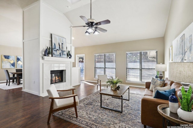 living room with a tiled fireplace, ceiling fan, high vaulted ceiling, and dark hardwood / wood-style floors