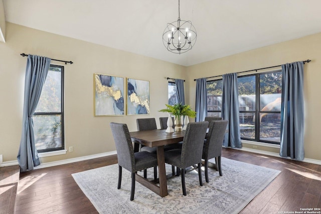 dining space featuring a chandelier, dark wood-type flooring, and a healthy amount of sunlight