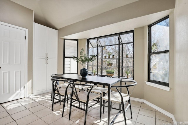 tiled dining space featuring a healthy amount of sunlight