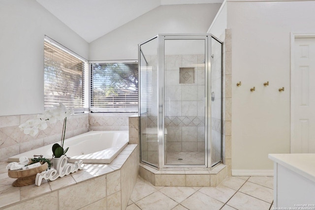 bathroom featuring tile patterned flooring, shower with separate bathtub, and lofted ceiling