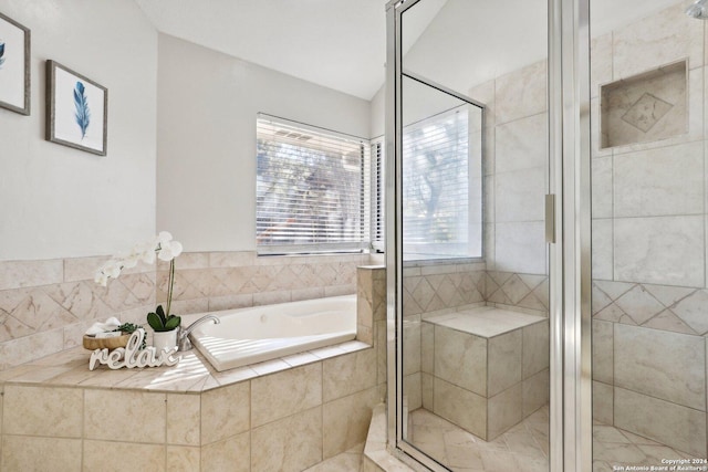 bathroom featuring shower with separate bathtub