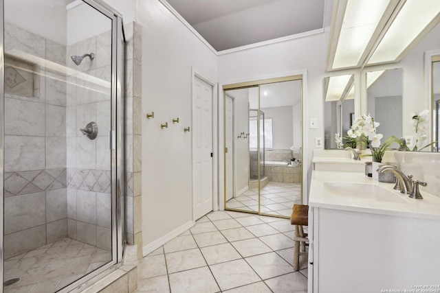 bathroom with tile patterned floors, separate shower and tub, and vanity