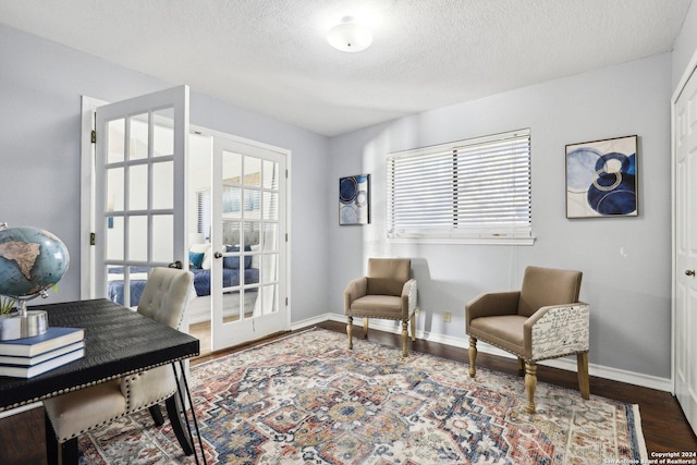 interior space featuring a wealth of natural light, french doors, a textured ceiling, and hardwood / wood-style flooring