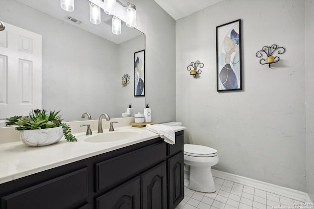 bathroom featuring tile patterned flooring, vanity, and toilet