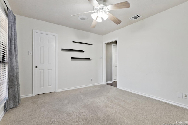 spare room with ceiling fan and carpet floors