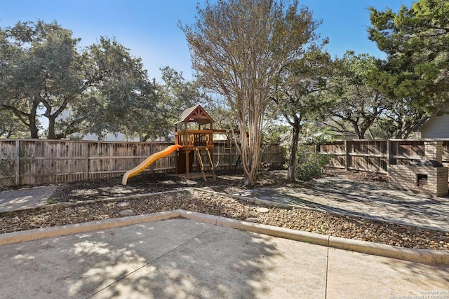 view of playground featuring a patio