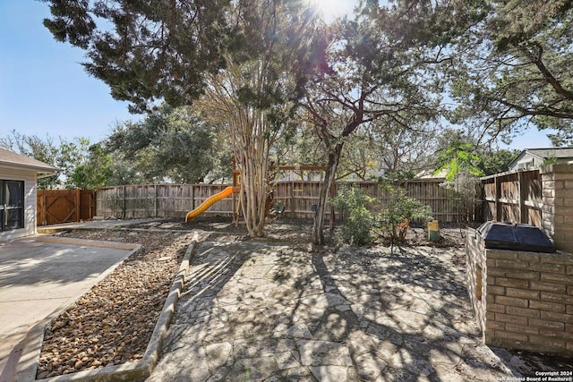 view of yard with a playground and a patio area