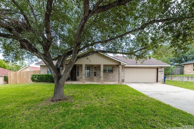 ranch-style house featuring a front lawn and a garage