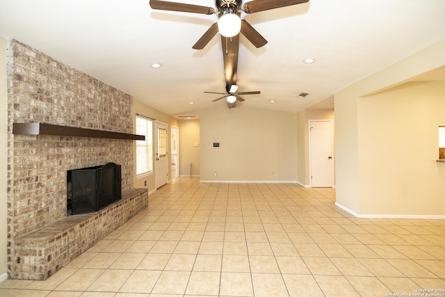 unfurnished living room featuring a fireplace, light tile patterned floors, ceiling fan, and lofted ceiling