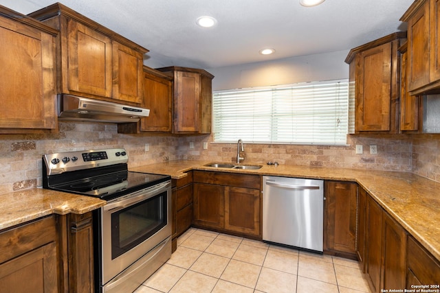 kitchen featuring backsplash, sink, stainless steel appliances, and extractor fan