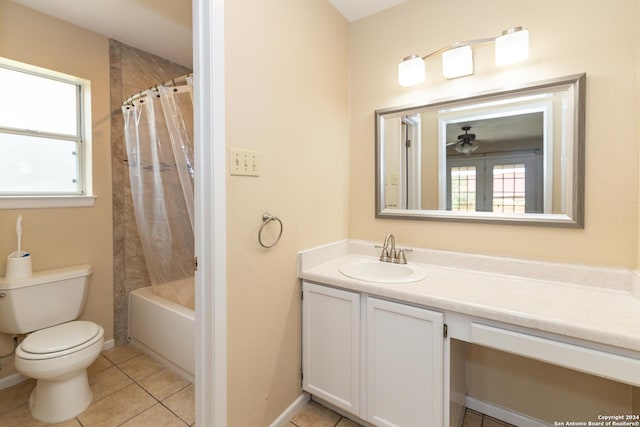 full bathroom featuring vanity, tile patterned floors, ceiling fan, toilet, and shower / bath combo with shower curtain