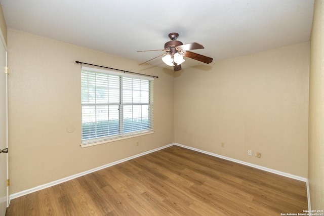 empty room with hardwood / wood-style flooring and ceiling fan