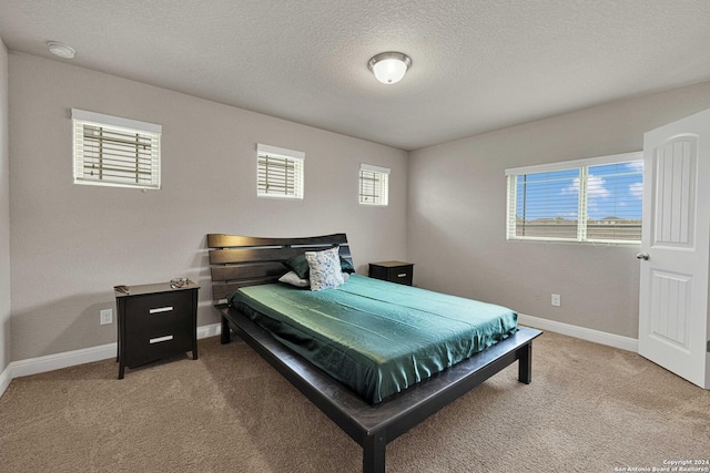 carpeted bedroom featuring a textured ceiling